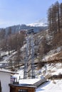 Funicular lift through snowy trees in Solden ski resort Austria