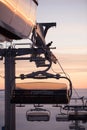 Funicular lifts/cable railway lifts. Pink sunset on top of the mountain. Snow all around, skiing resort beauty.