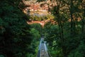 Funicular with view from the mountain Petrin in Prague with trees in sunshine and river Vltava in the background