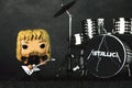 Funko POP vinyl figure of James hetfield singer of the american heavy metal group Metallica next to the battery. Illustrative