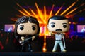 Funko POPO vinyl figures of Freddie Mercury and John Deacon(Queen) on concert stage background Royalty Free Stock Photo