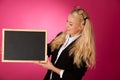 Funky business woman holding a blank blackboard - teacher Royalty Free Stock Photo