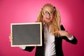 Funky business woman holding a blank blackboard - teacher Royalty Free Stock Photo