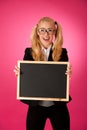 Funky business woman holding a blank blackboard - teacher Royalty Free Stock Photo