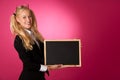 Funky business woman holding a blank blackboard - teacher Royalty Free Stock Photo