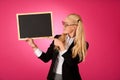 Funky business woman holding a blank blackboard - teacher Royalty Free Stock Photo