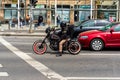 Funky hipster riding a vintage custom motorcycle in Bucharest, Romania, 2020