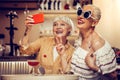 Funky trendy old women making selfie together while visiting bar