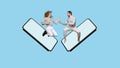 Funne design. Collage of cheerful man and woman jumping out phone screen and jokingly fighting isolated over blue