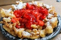 Funnel cake with strawberry topping Royalty Free Stock Photo