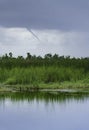 A funnel cloud or waterspout over the Louisiana marsh