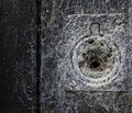 Funnel spider web covering up keyhole on old wooden door