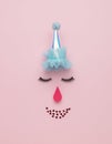 Funny abstract clown face on pink background. The concept of a modern circus