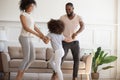 Funny active family with little kid dancing in living room Royalty Free Stock Photo