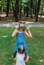 Funny active kids playing on green grass in spring park