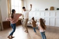 Funny active parents and children daughters dancing in living room Royalty Free Stock Photo