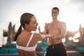 Excited woman smiling and holding hands with her boyfriend Royalty Free Stock Photo