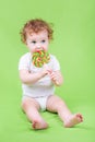 Funny adorable baby with a big candy