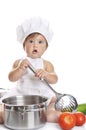 Funny adorable baby boy chef sitting and playing Royalty Free Stock Photo