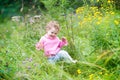 Funny adorable baby girl walking in the garden