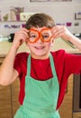 Funny adorable boy with sliced paprika on eyes Royalty Free Stock Photo