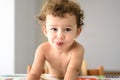 Funny adorable little girl with humorous expression during meal