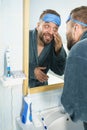 Sleepy man looking at mirror Royalty Free Stock Photo