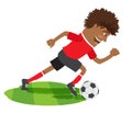 Funny African American soccer football player wearing red t-shirt running kicking a ball and smiling