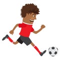 Funny African American soccer football player wearing red t-shirt running kicking a ball and smiling Royalty Free Stock Photo