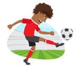 Funny African American soccer football player wearing red t-shirt running kicking a ball and smiling Royalty Free Stock Photo