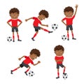 Funny African American soccer football player wearing red t-shirt running, standing and kicking a ball and smiling Royalty Free Stock Photo