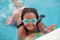 Funny afroamerican girl with goggles in the pool Royalty Free Stock Photo