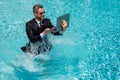 Funny amazed businessman in suit with laptop in swimming pool. Crazy excited business man on summer vacation. Excited Royalty Free Stock Photo