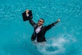 Funny amazed businessman in suit with laptop in swimming pool. Crazy excited business man on summer vacation. Excited Royalty Free Stock Photo