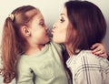 Funny amusing young mother wanting to kiss her comical grimacing