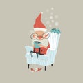 Funny angry Santa Claus sitting in armchair and drink cocoa