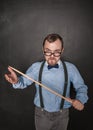 Funny angry teacher in eyeglasses with pointer on blackboard