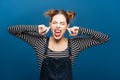 Funny angry woman with closed eyes covered ears by fingers Royalty Free Stock Photo