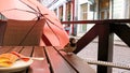 Tourism in Europa Street cafe table with cup of coffee umbrella   on chair and sparrow sit on table eating sweet cake travel to Eu Royalty Free Stock Photo