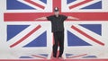 Artistic man with custodian helmet is imitating pointsman at studio with UK flag