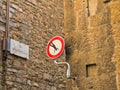 Funny artistic modification of a traffic sign in a small alley at downtown of Florence in Tuscany