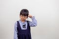 funny Asian child girl wearing glasses on a white background