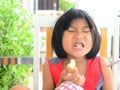 Funny Asian girl eating tasty bread