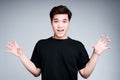 Funny asian guy in black t-shirt and short hair fooling around and acts like a bear roar Royalty Free Stock Photo