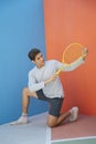 Funny asian guy holding tennis racket Royalty Free Stock Photo