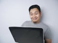 Funny Asian Man Working on His Laptop, Smiling Expression Royalty Free Stock Photo