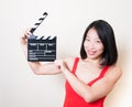 Funny asian woman red dress with movie clapperboard on white Royalty Free Stock Photo