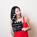 Funny asian woman red dress with movie clapperboard on white Royalty Free Stock Photo