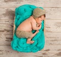 Funny asleep newborn baby in wicker cot Royalty Free Stock Photo