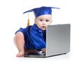 Funny baby in academician clothes at laptop